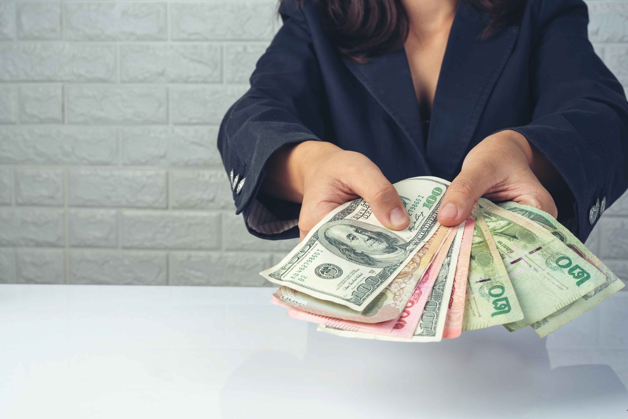 woman-employees-counting-money-white-desk (1) Debt Consolidation in Alberta<br />